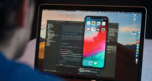 A trading app created using Deriv API shown on a laptop.
